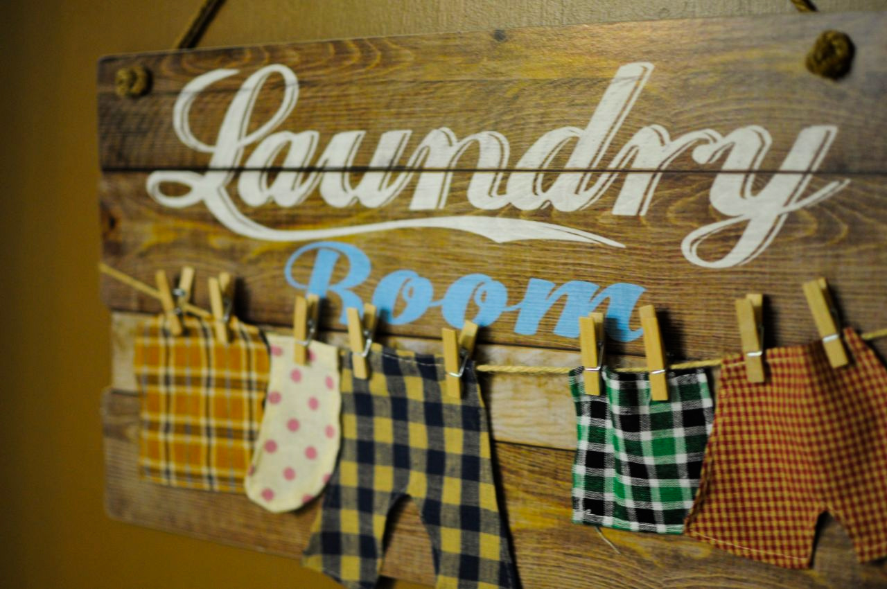 a sign of clothes hanging on a line Laundry Room