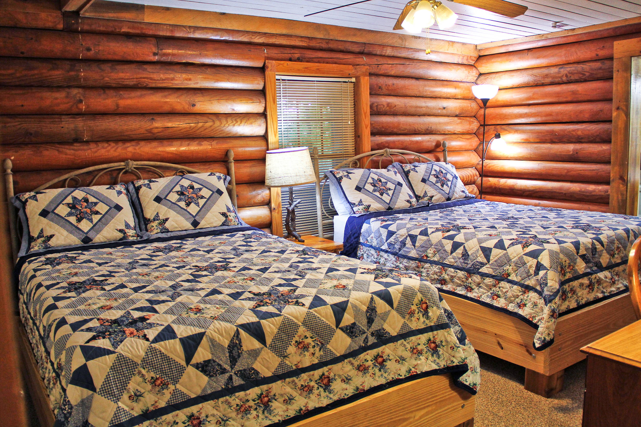 log cabin bedroom with 2 beds