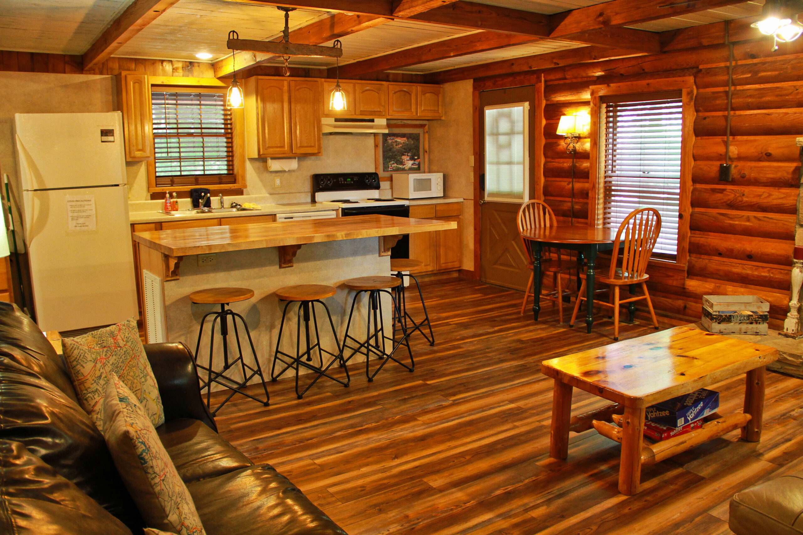 view of kitchen area island and table with 2 chairs