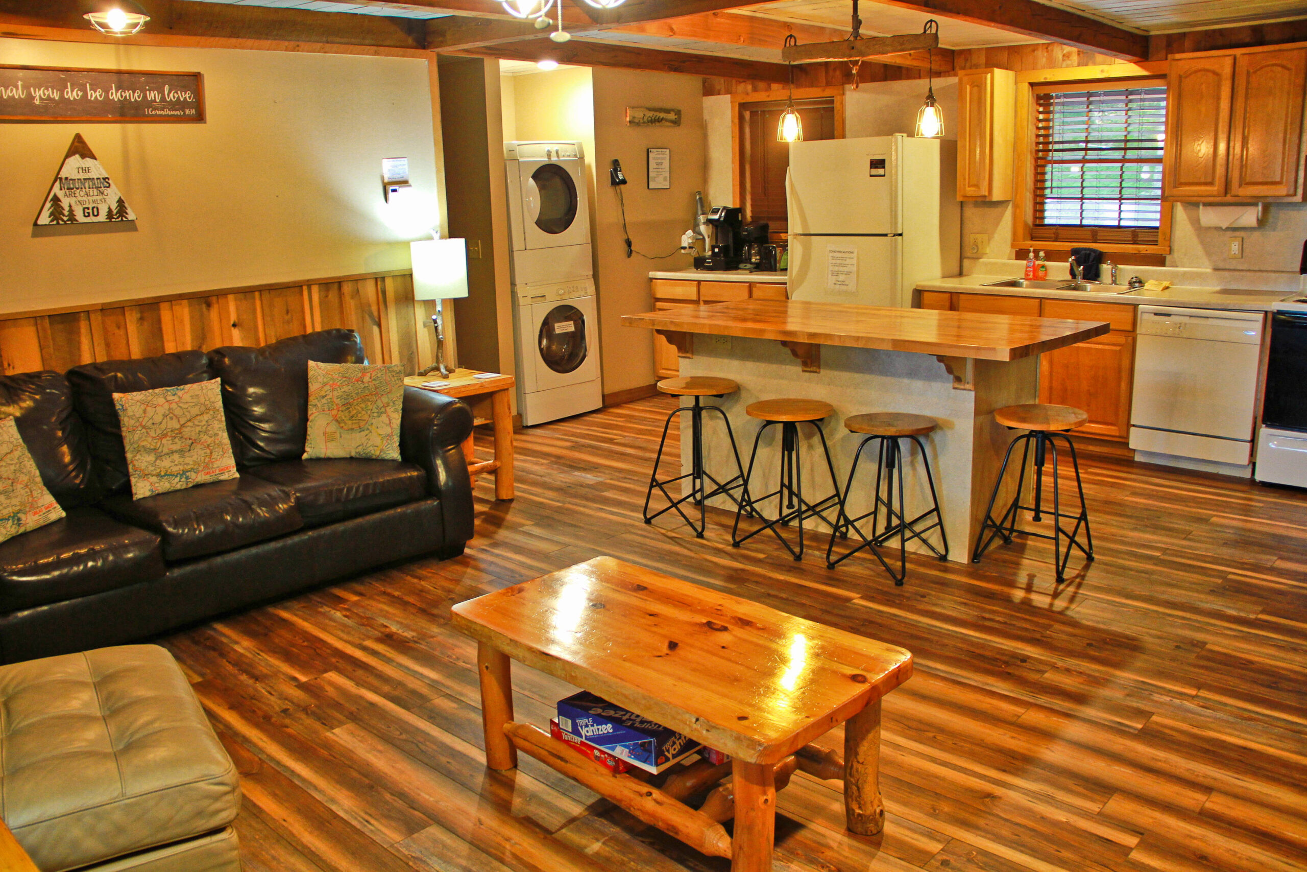 view of sofa, kitchen island with 4 chairs and washer and dryer