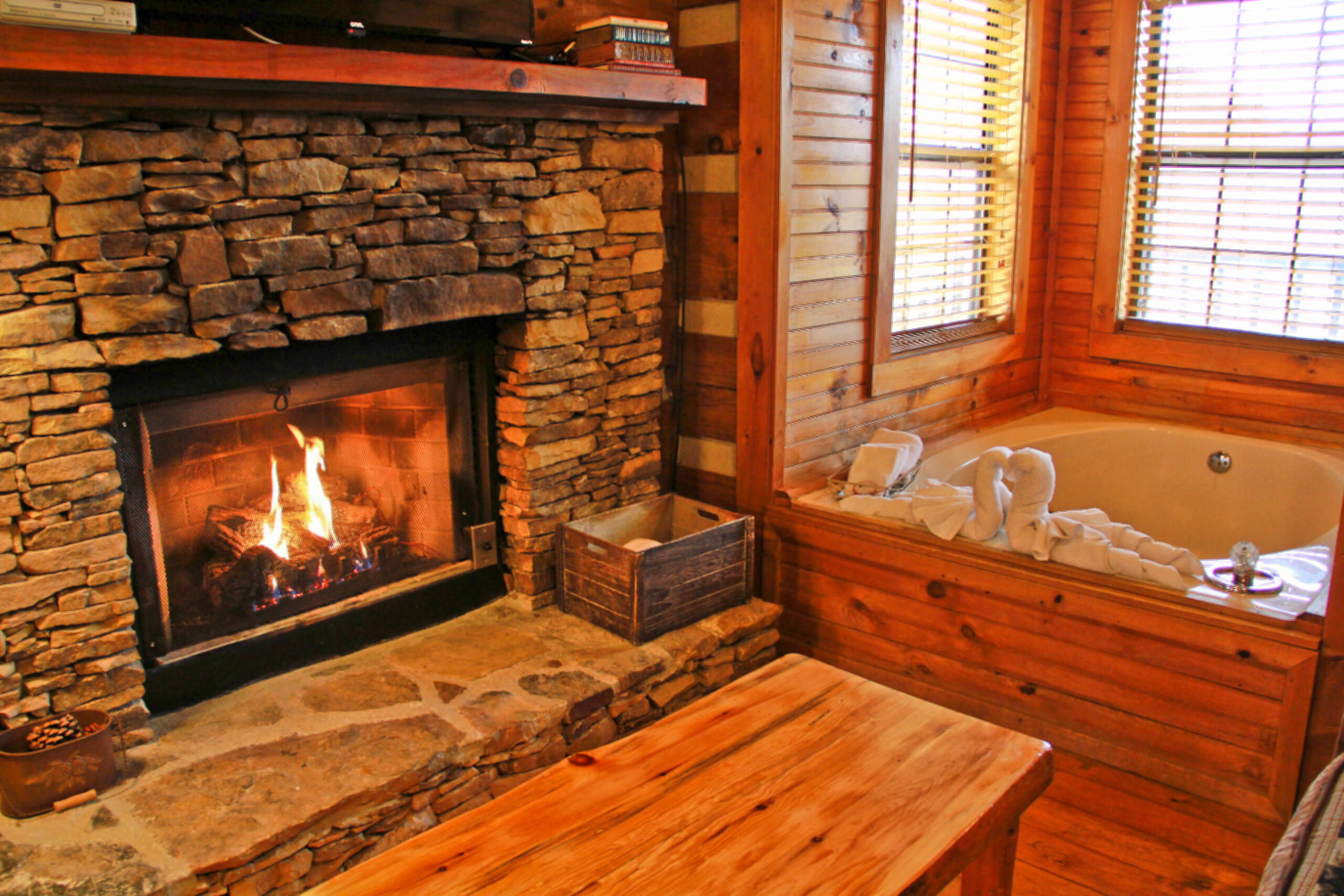 stone fireplace, hot tub with window views
