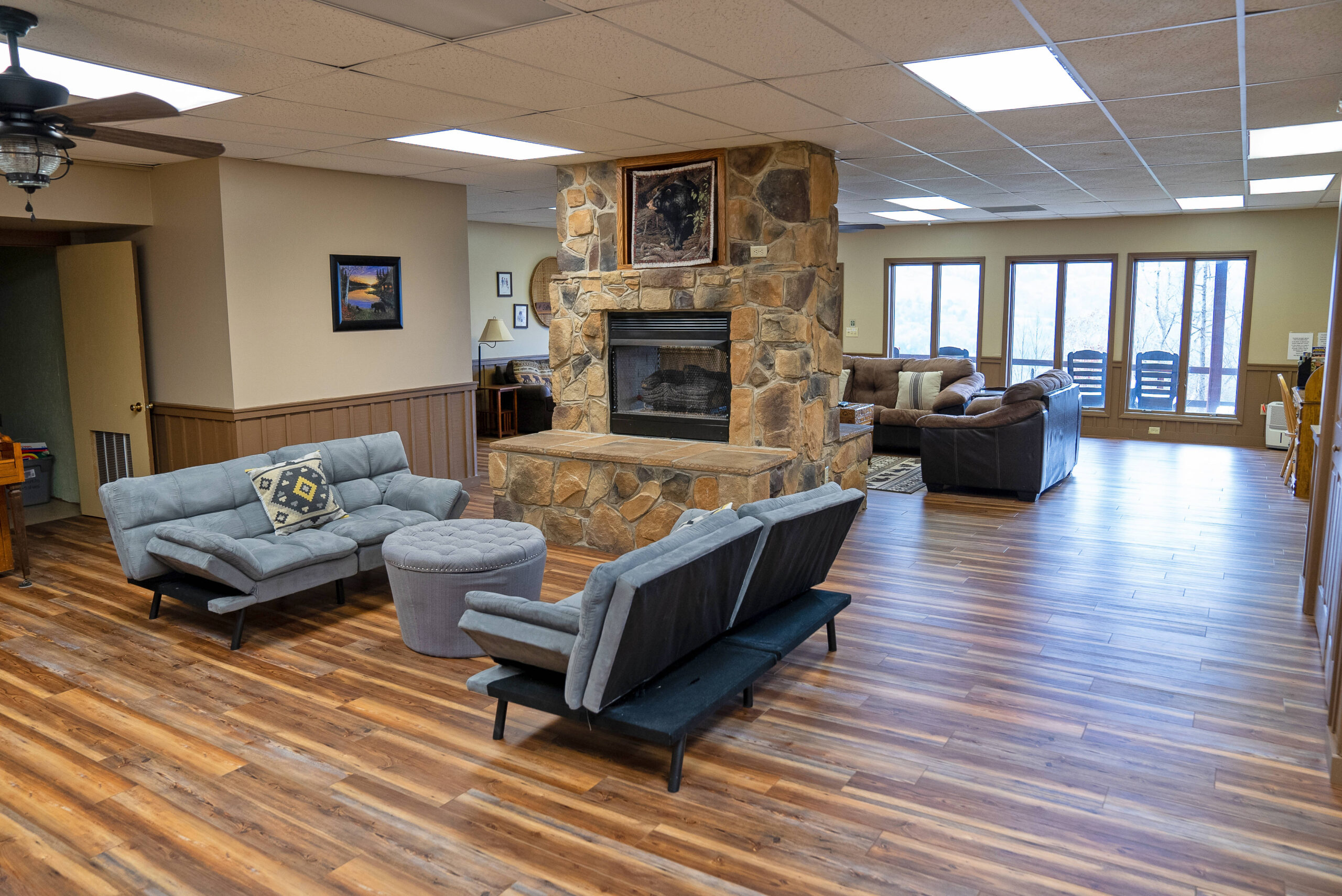 living area with sofas and stone fireplace