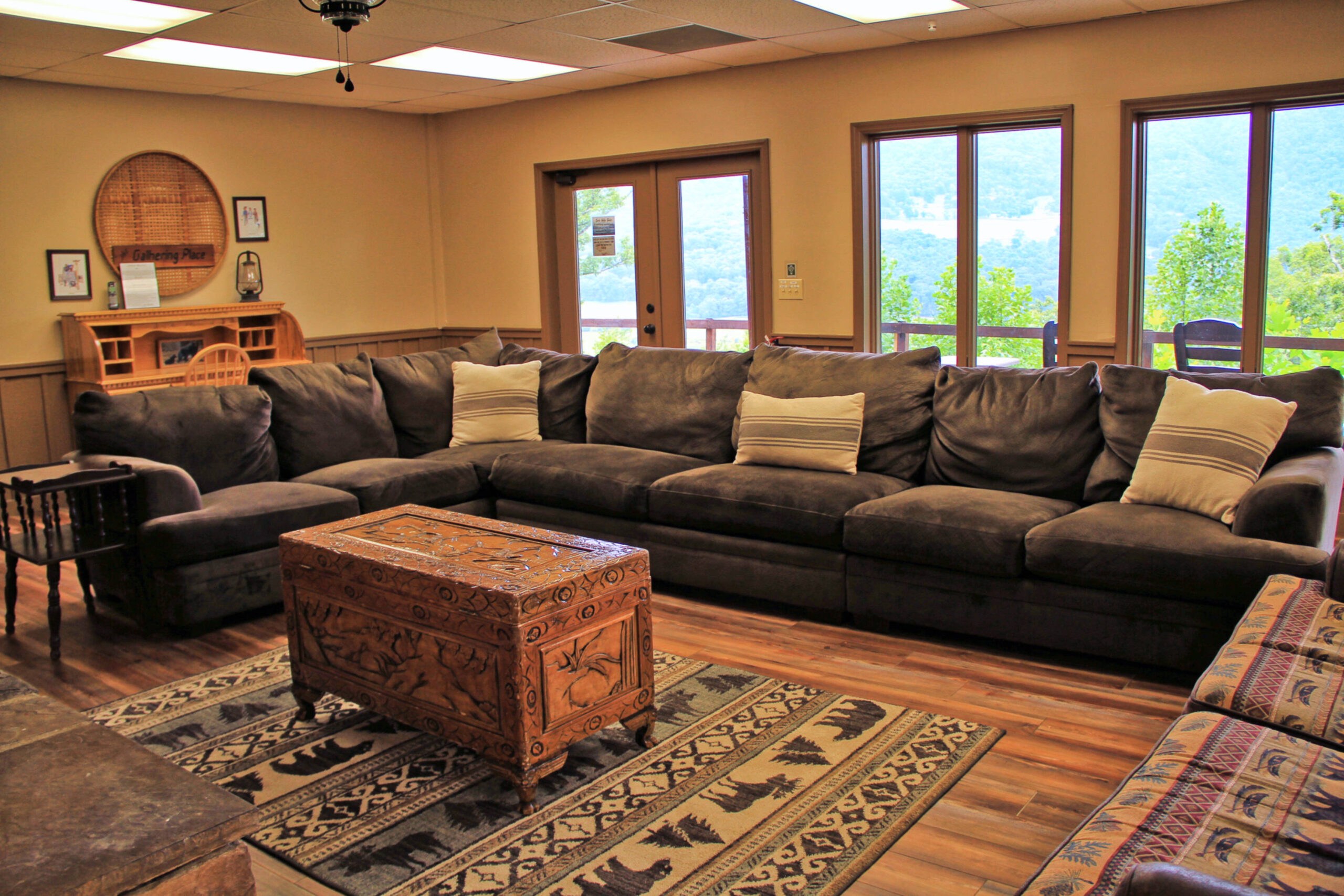 living room area with sofa and desk