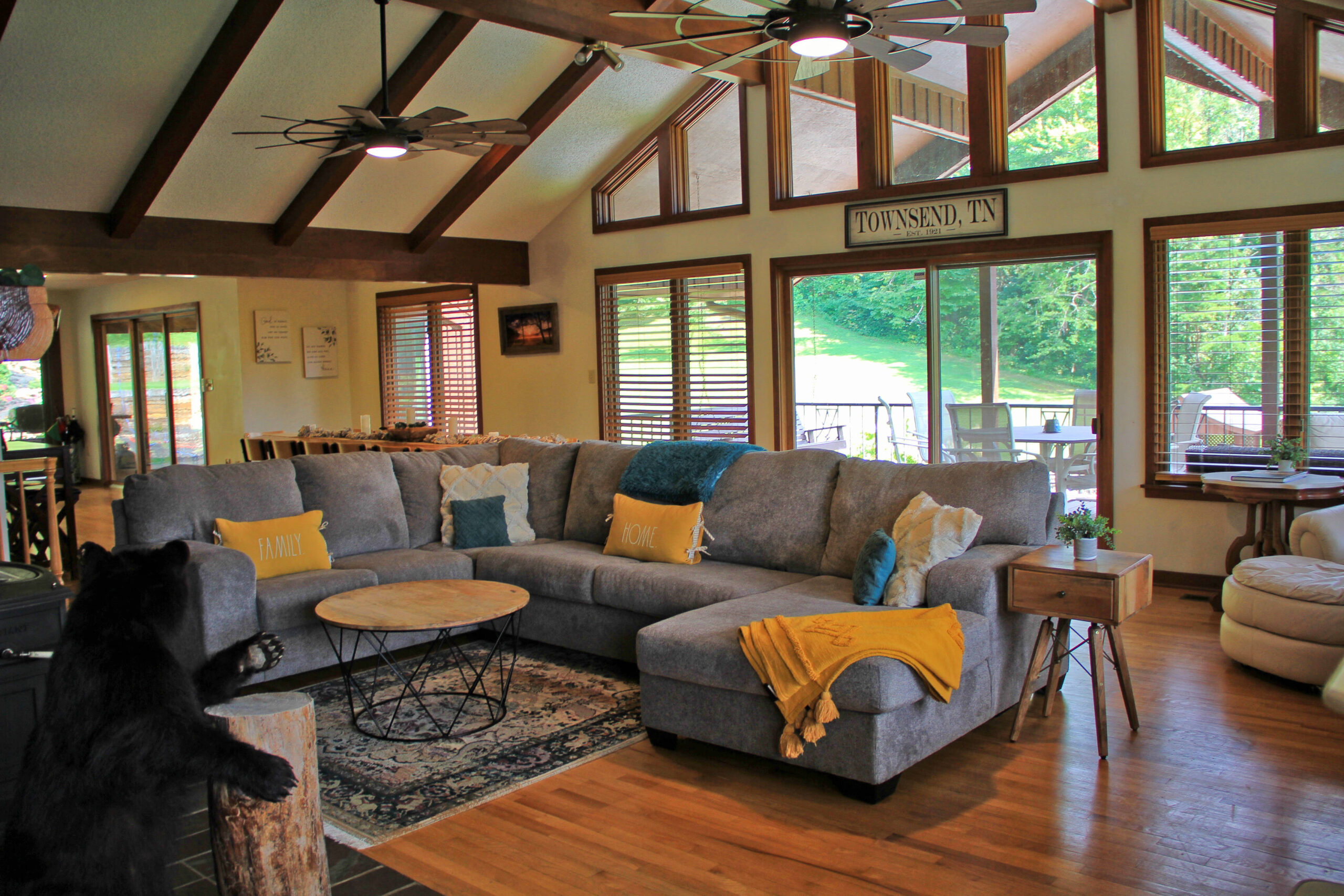 living room with sofa, large windows with view of pool area