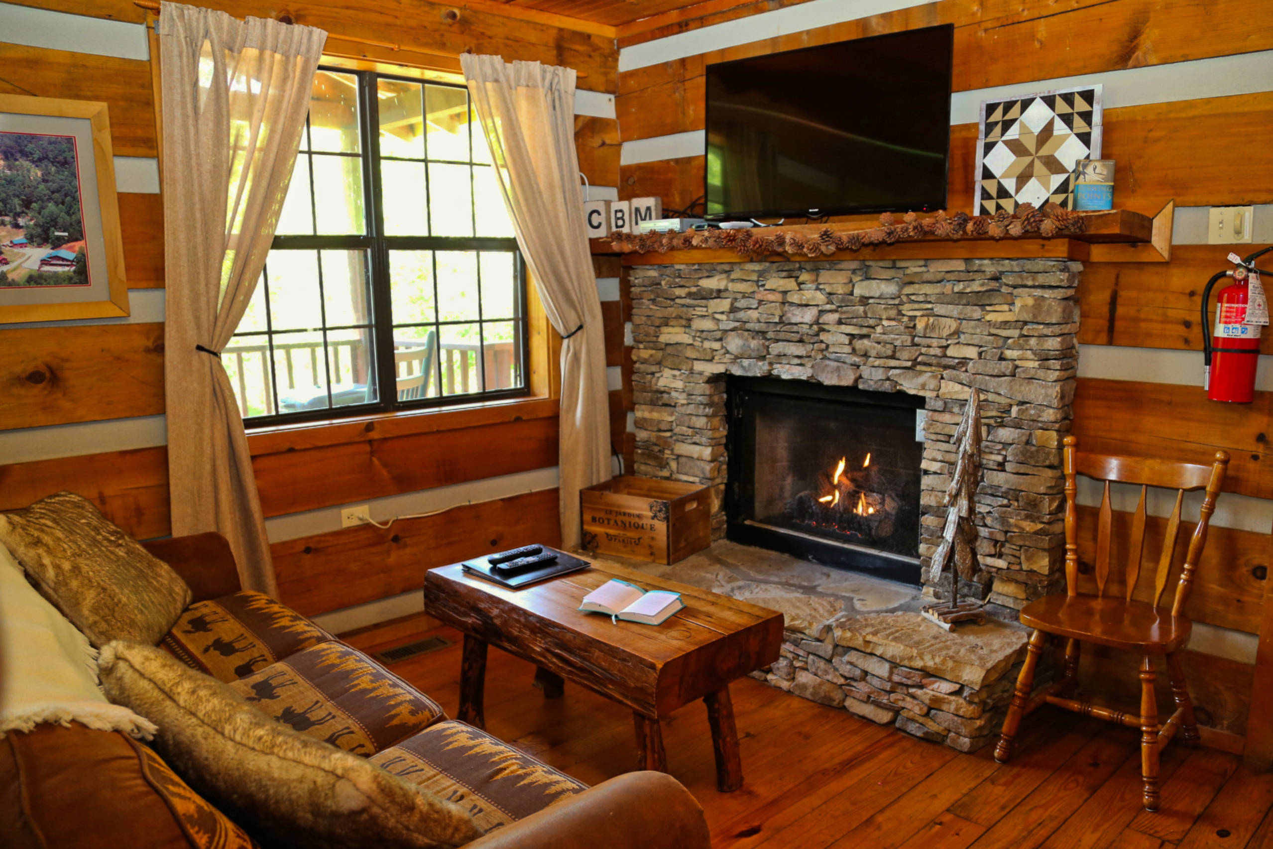 stone fireplace with TV on top and sofa