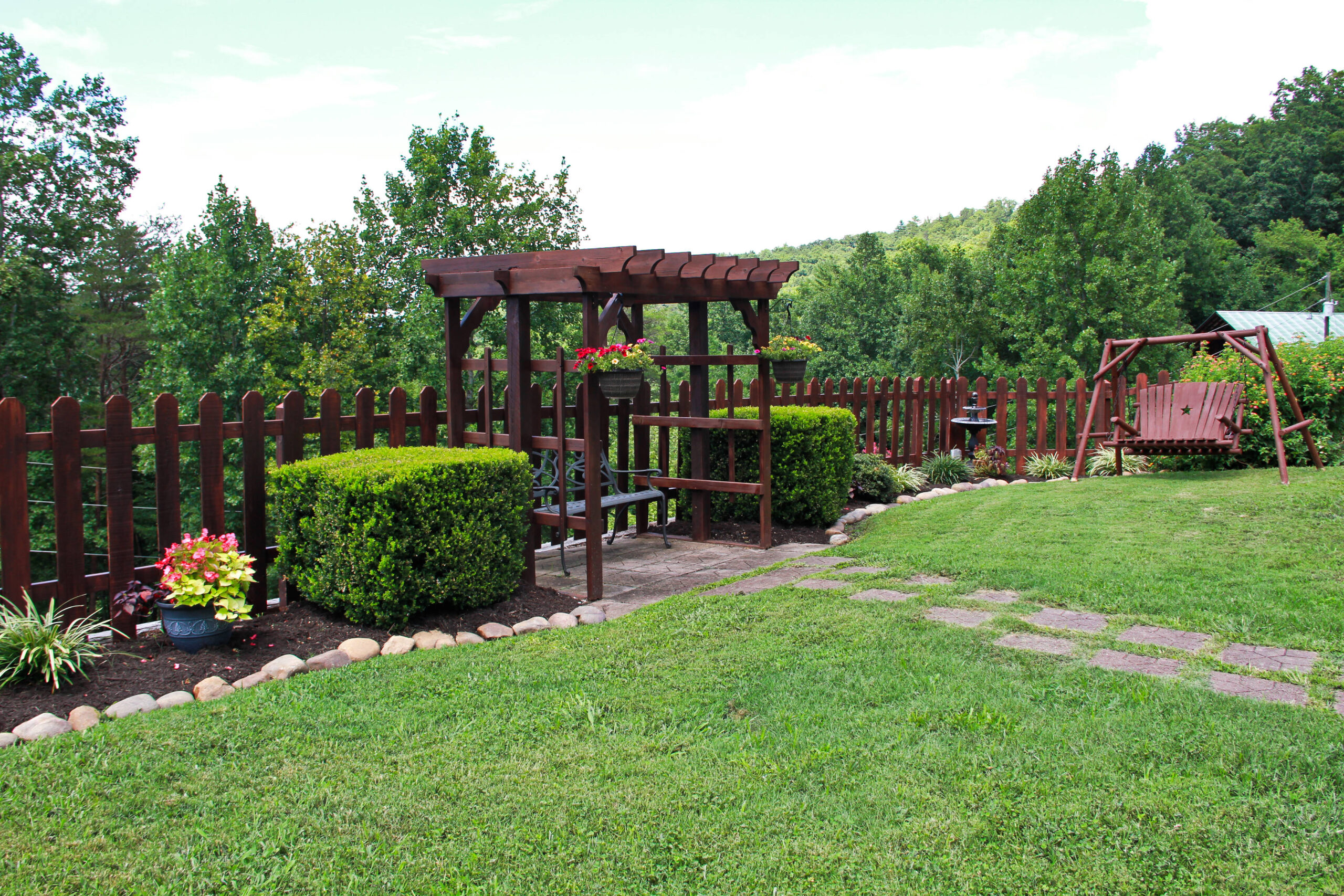 view of garden area with swing and chair and fountain